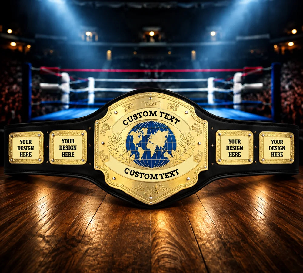 A custom championship-style belt with a large gold central plate featuring a blue globe emblem and four smaller gold side plates, displayed on a wooden surface with a blurred boxing ring arena in the background.