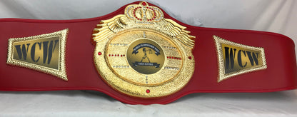 A red and gold WCW wrestling championship belt 
