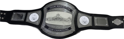 A golf championship belt with a large central silver-toned plate reading 'TEAM MATCH PLAY 2026 CHAMPIONS' and 'MCCY 2026,' flanked by two smaller silver plates and black straps on a white background.